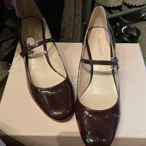 Burgundy patent leather Mary Jane with a gold heel.